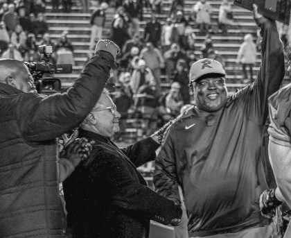 State Sen. Rodger Smitherman, D-Birmingham, and interim Birmingham School Superintendent Larry Contri congratulate Ramsay coach Reuben Nelson after his Rams beat Austin 24-14 to win their Class 6A Alabama High School Athletic Association semifinal on Frid